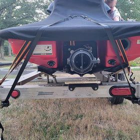 YAYODS strap securing boat and ATV cargo for safe transport.
