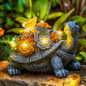 YDKOJGW solar garden statue tortoise with succulent glows softly at night outdoors.