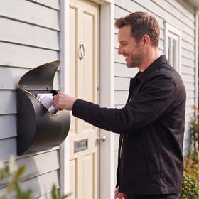 Yielycan mounted mailbox on wall shows weather-ready installation for homes