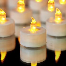 YIWER tea lights emit a warm yellow glow for elegant events.