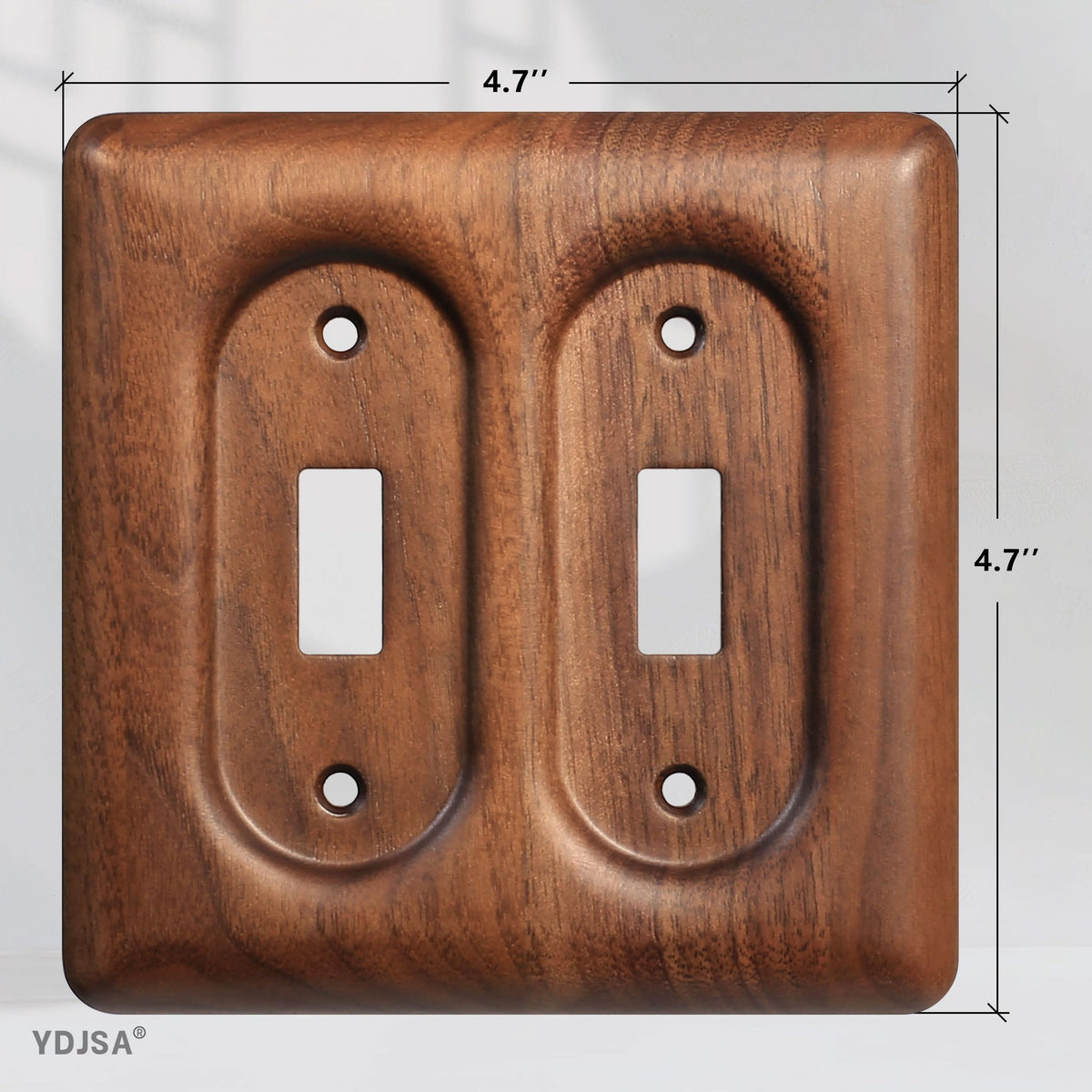 YDJSA two-gang walnut wall plate installed on wall with warm lighting.