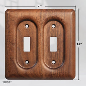 YDJSA two-gang walnut wall plate installed on wall with warm lighting.