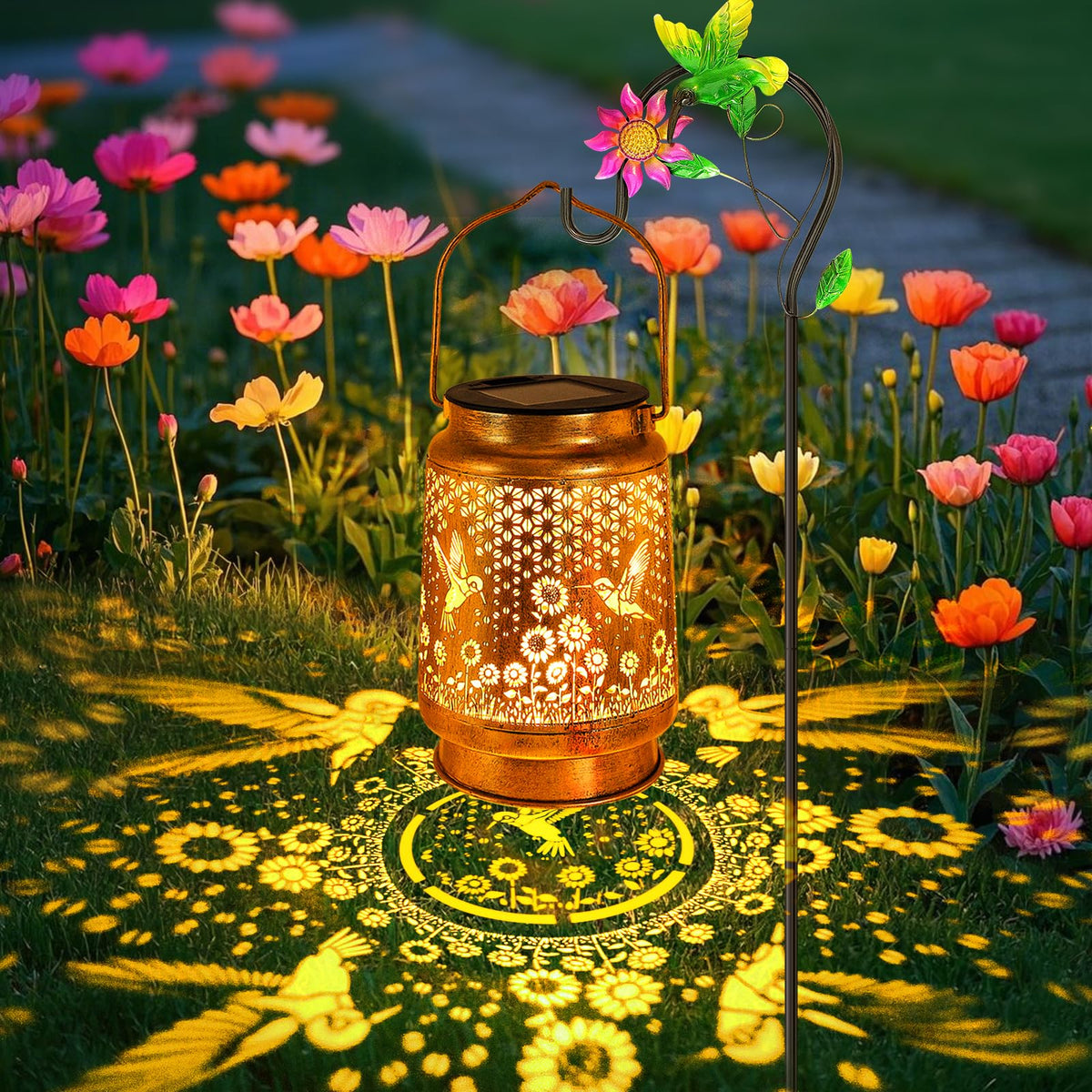 YJFWAL hummingbird-sunflower-solar-lantern on shepherd hook creates warm garden ambiance after dusk.