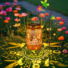 YJFWAL hummingbird-sunflower-solar-lantern on shepherd hook creates warm garden ambiance after dusk.