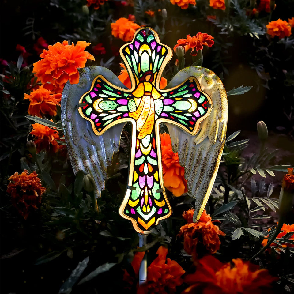 YJFWAL solar glass cross garden stake light illuminating a walkway at dusk
