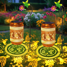 yulloyello hummingbird lantern on a wall or hook casting warm bronze glow.