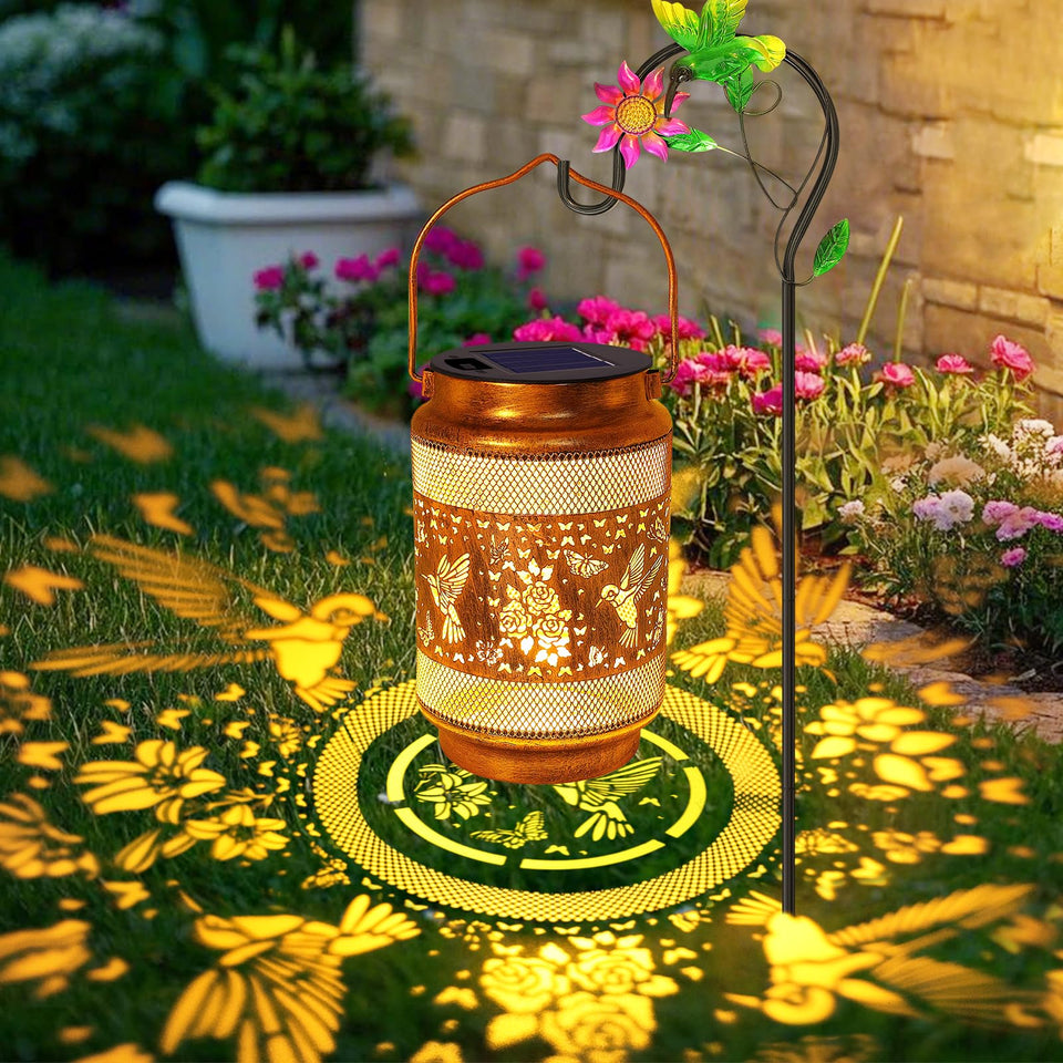 Yulloyello hummingbird lantern in gold bronze with openwork pattern for warm garden ambiance.