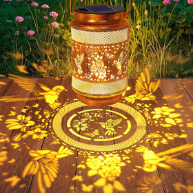 yulloyello hummingbird lantern openwork pattern decorates outdoor space at night.