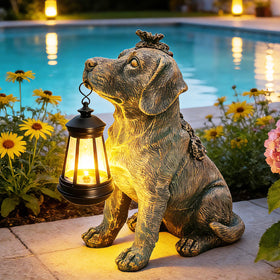 Yulloyello lantern-dog statue glowing softly at night in the yard.