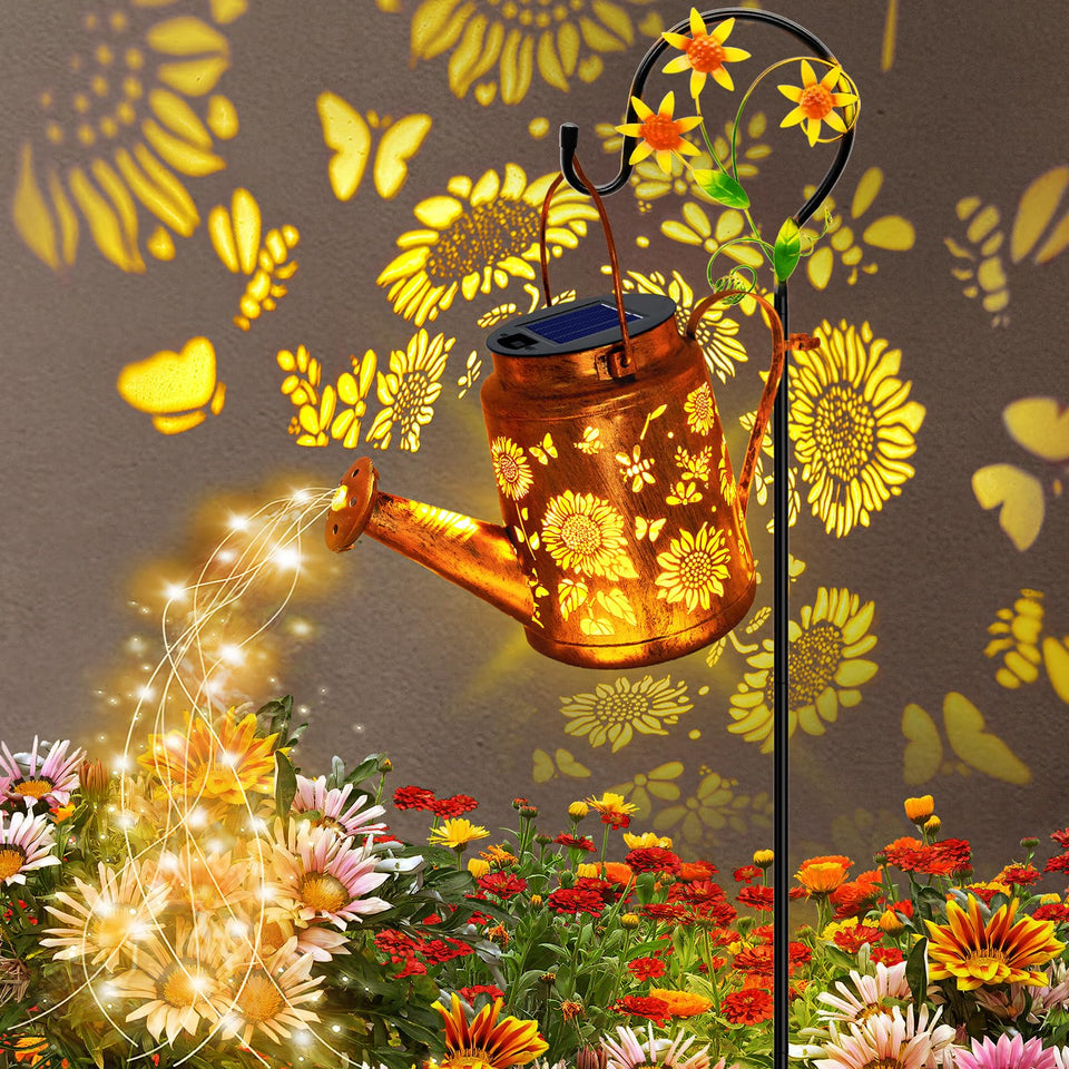 Yulloyello solar watering can with lights illuminates the garden path at night.