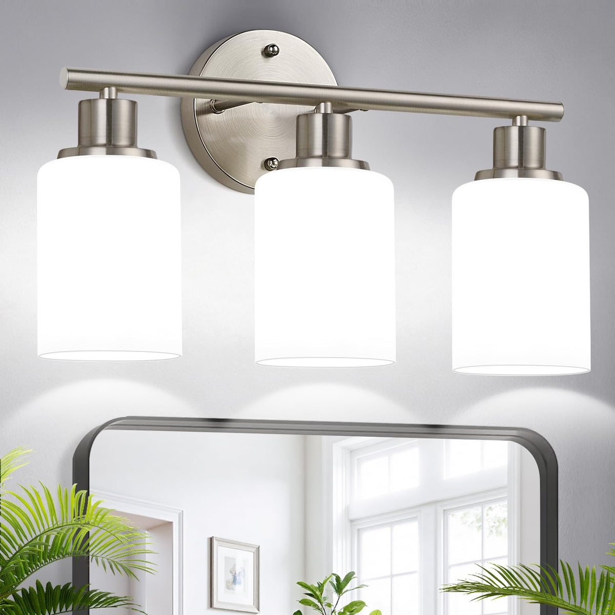 Zarbitta 3-light brushed nickel vanity light over mirror provides modern, even illumination.