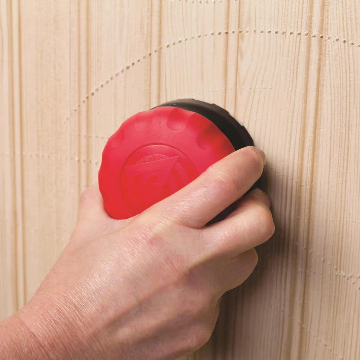 Close-up of PaperTiger scoring disks perforating a wallcovering to attack paste.