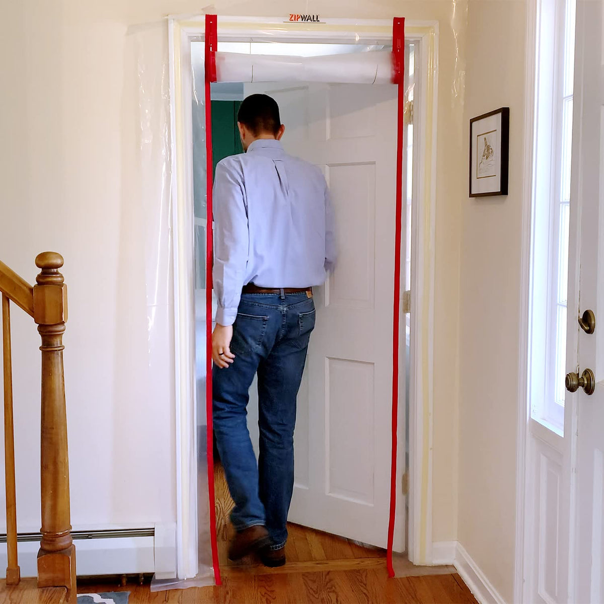 Sealed doorway setup for dust containment in a residential remodel.