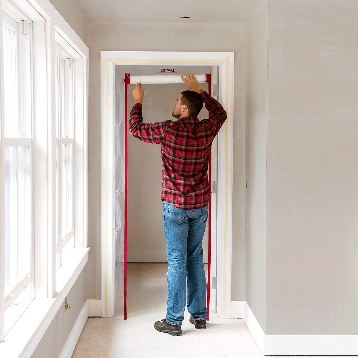 ZIPWALL ZIPDoor panel with preinstalled zippers supports easy access during remodeling.
