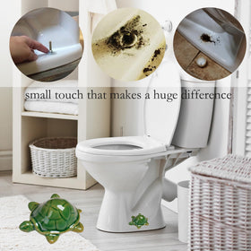 Two green frog toilet bolt caps installed over standard bolts