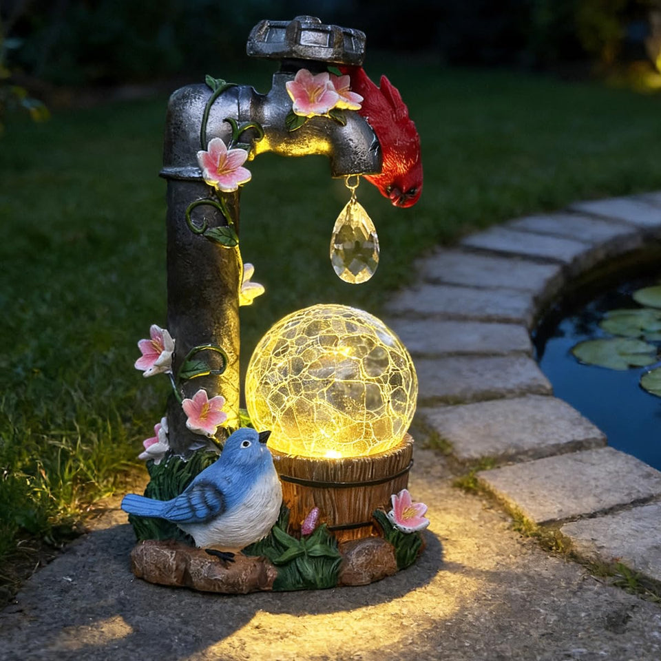 ZYLiWoo solar cardinal garden statue with water faucet and glass ball glows gently at night.